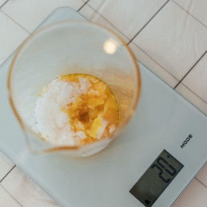 Ingredients being mixed in a beaker at Sage Cosmetic Coaching workshop