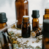 amber essential oil bottles surrounded by dried botanicals.