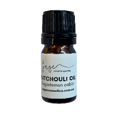 Bottle of patchouli oil with a white label on a white background