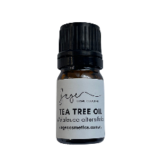 Tea tree oil bottle with black cap and white label on a white background