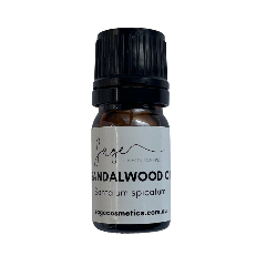 Sandalwood oil bottle with black cap and white label on a white background