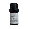 Bottle of Cedarwood Atlas essential oil with a black cap on a white background