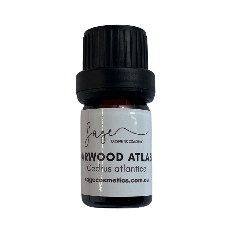 Bottle of Cedarwood Atlas essential oil with a black cap on a white background