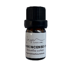 Bottle of frankincense oil with a black cap on a white background