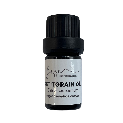 Bottle of petitgrain oil with a black cap on a white background
