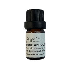 Bottle of rose absolue oil with a black cap on a white background