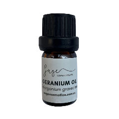 Bottle of geranium oil with a black cap on a white background