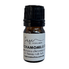 Small bottle of chamomile essential oil with a black cap on a white background
