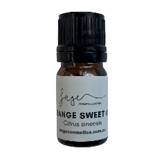 Bottle of orange sweet oil with a black cap on a white background